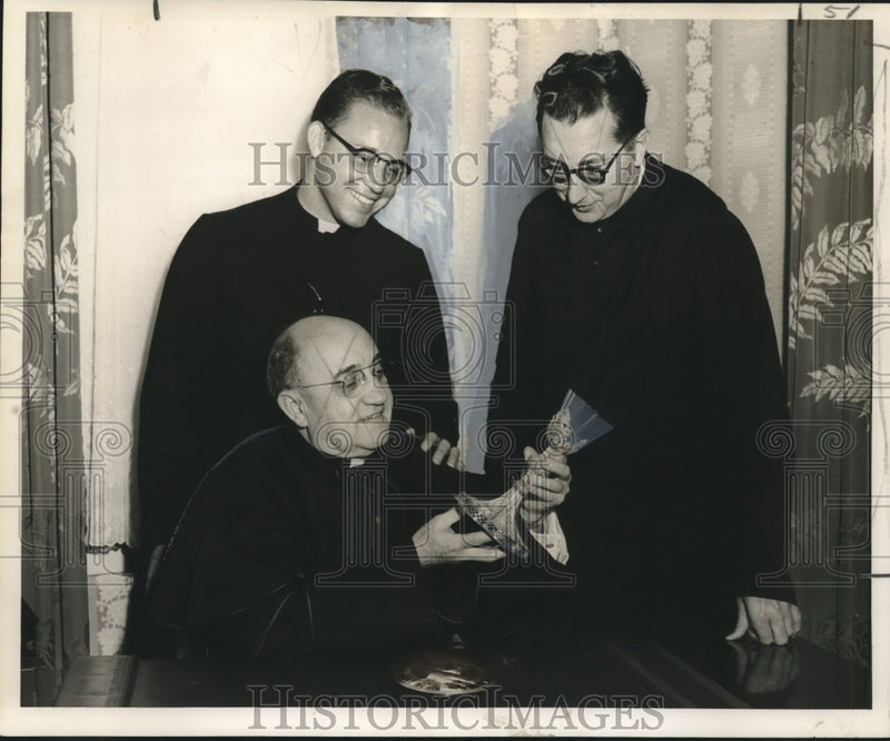 Load image into Gallery viewer, 1957 Press Photo St. Rose of Lima Church priests examine parishioner heirlooms
