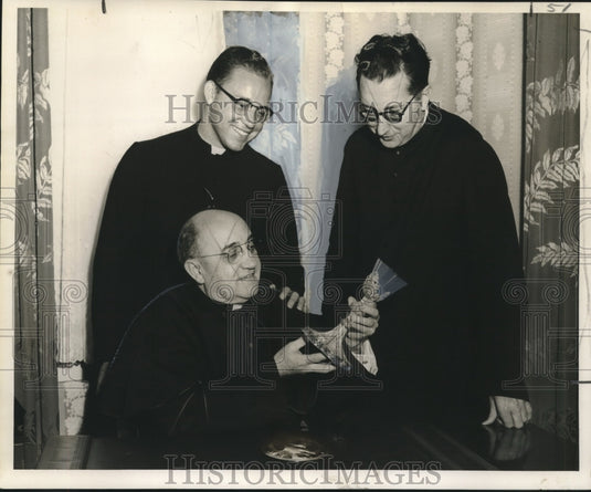 1957 Press Photo St. Rose of Lima Church priests examine parishioner heirlooms