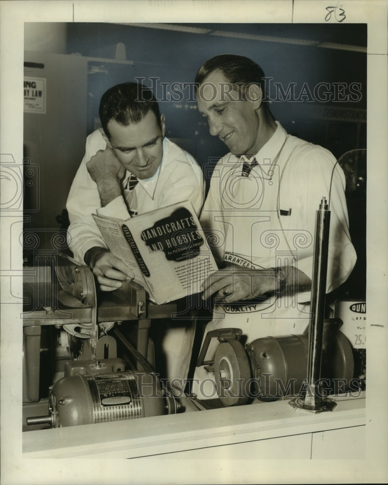 1950 Press Photo H.C. Meyer &amp; N.J. Dugas with a copy of a book contests will get