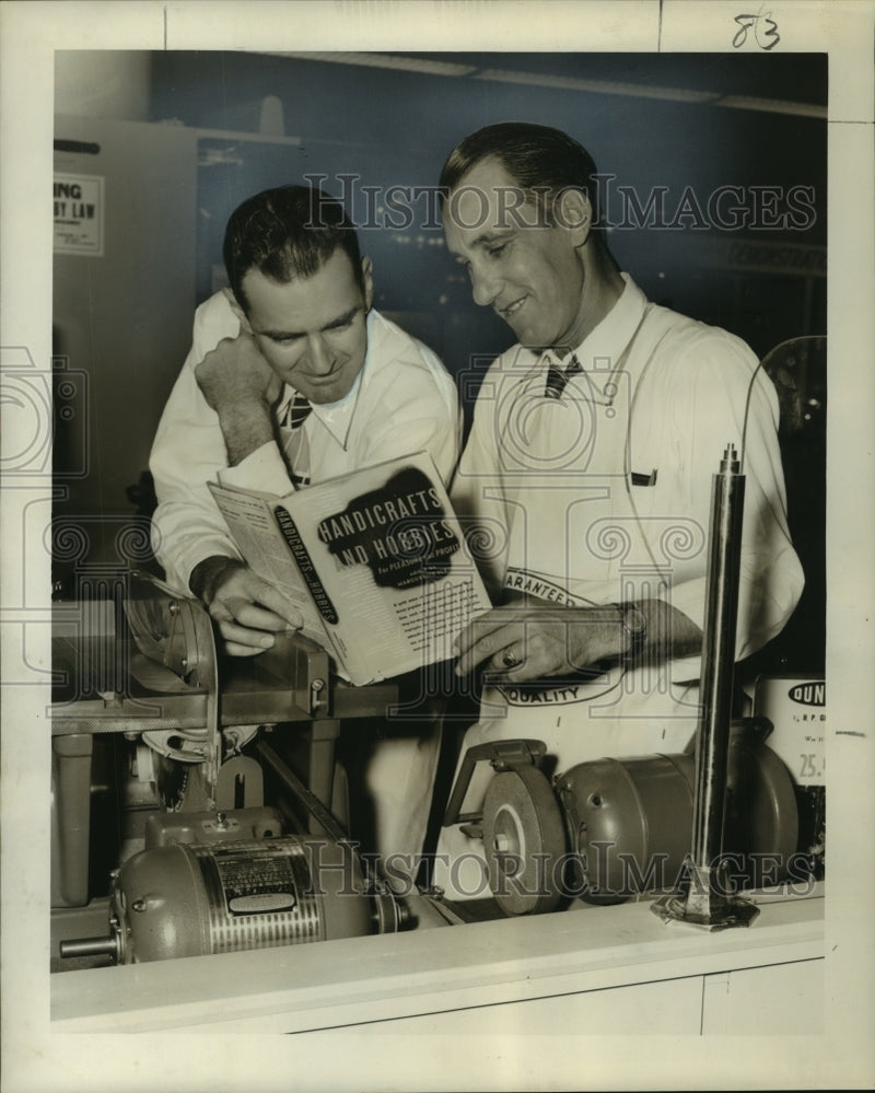 Load image into Gallery viewer, 1950 Press Photo H.C. Meyer &amp; N.J. Dugas with a copy of a book contests will get
