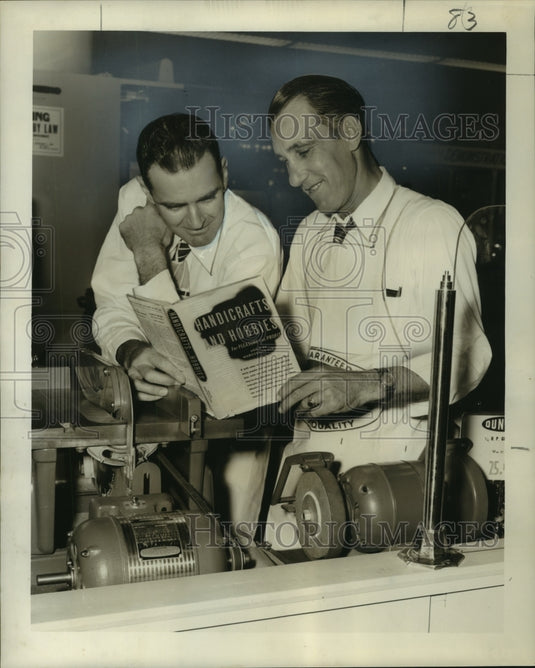 1950 Press Photo H.C. Meyer & N.J. Dugas with a copy of a book contests will get