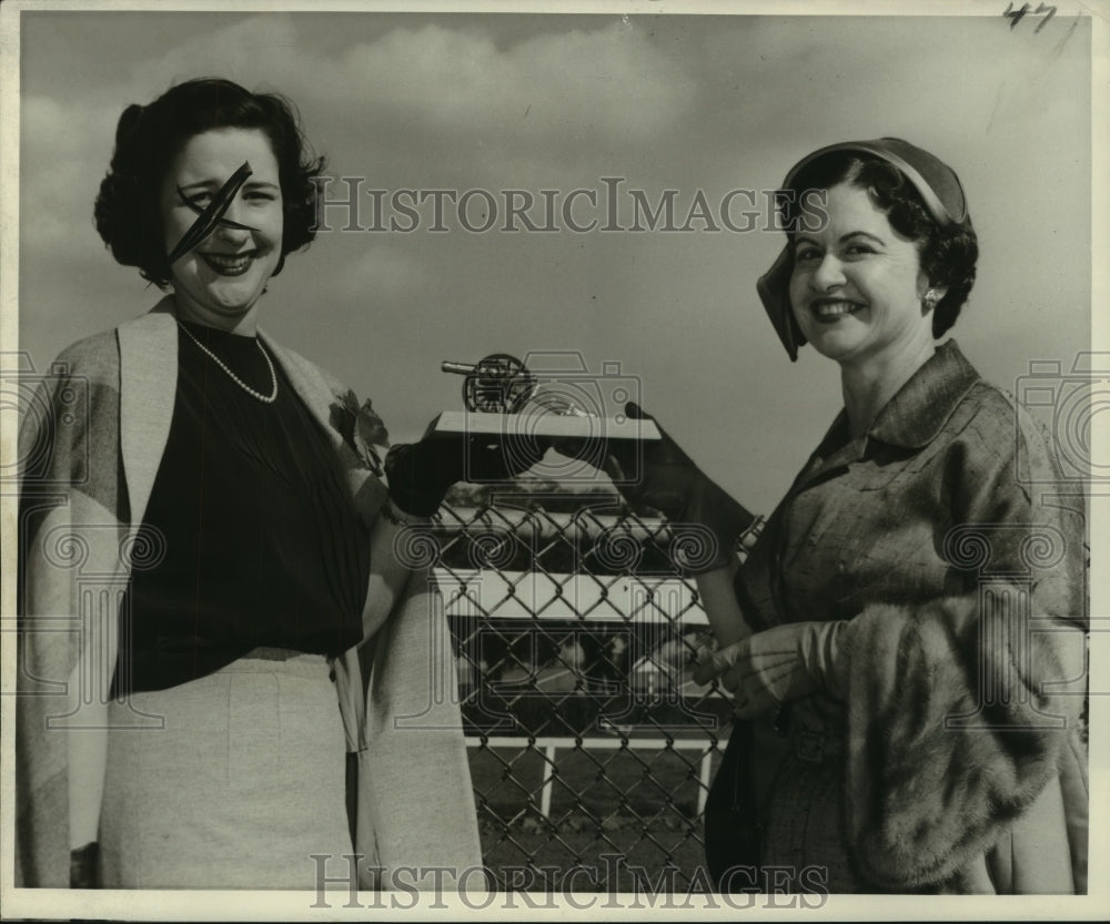 1957 Press Photo Mrs. H. Richmond Favrot with another holding miniature cannon