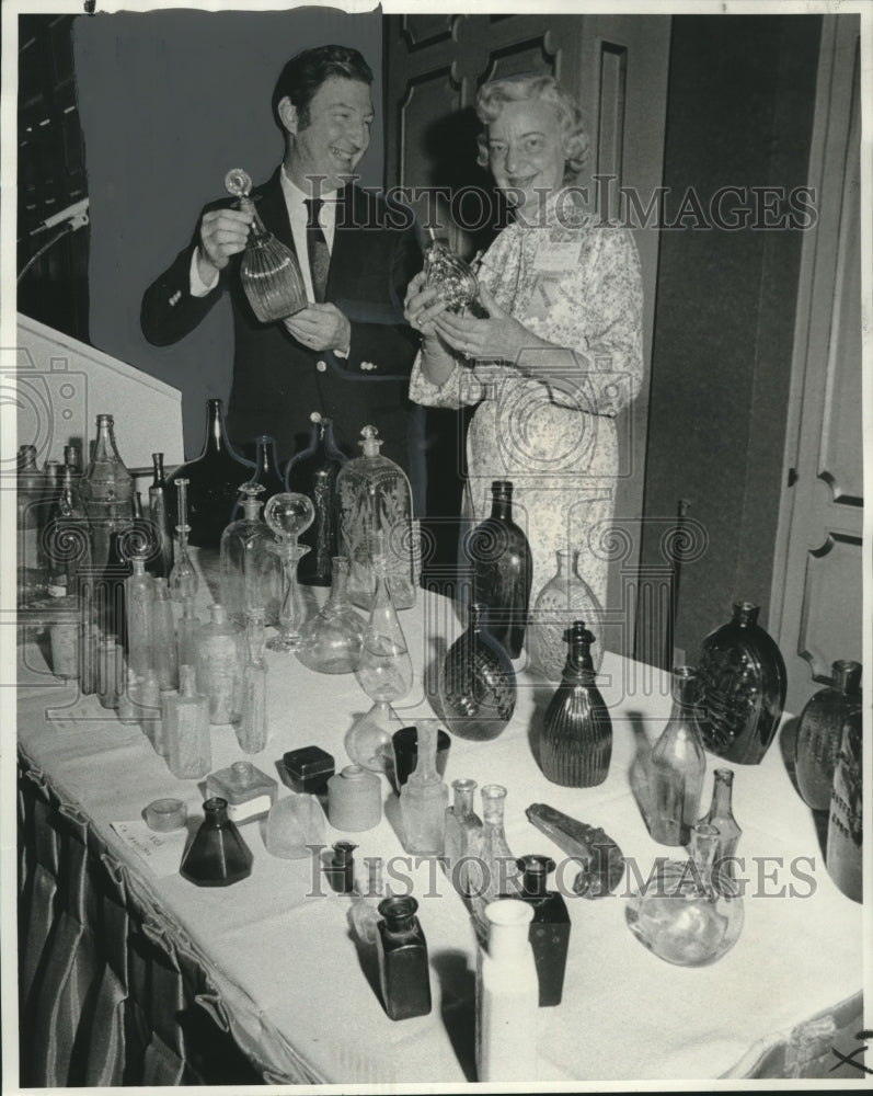 Load image into Gallery viewer, 1975 Press Photo Lawrence Eustis shows his bottle collection to Mrs. Heft.
