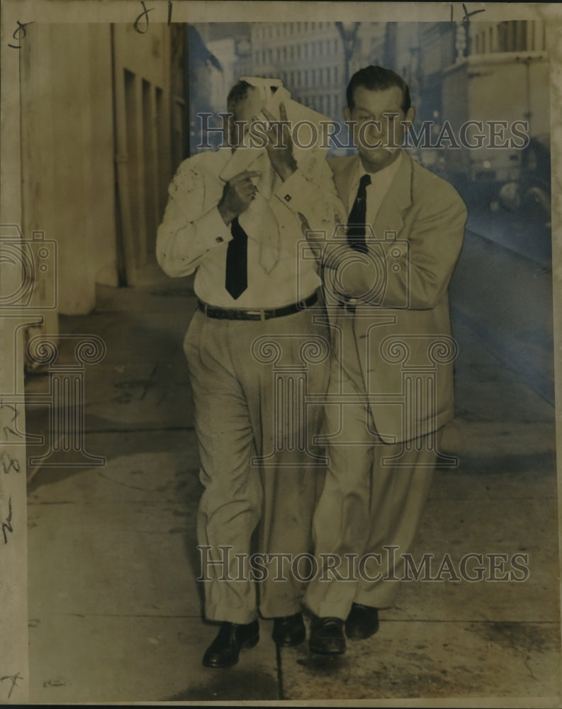 Load image into Gallery viewer, 1957 Press Photo Frank Buckley Assists Airel Frank after Robbery, New Orleans
