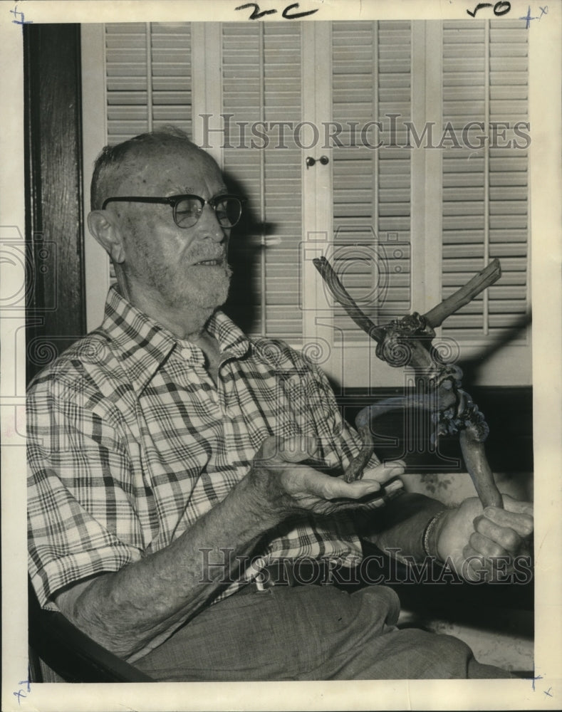 1974 Press Photo  Dr. L.A. Fortier admires rose sculpture - Historic Images