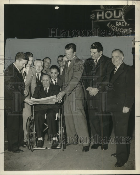 1952 Press Photo Commissioner Moore reads news paper under new lights