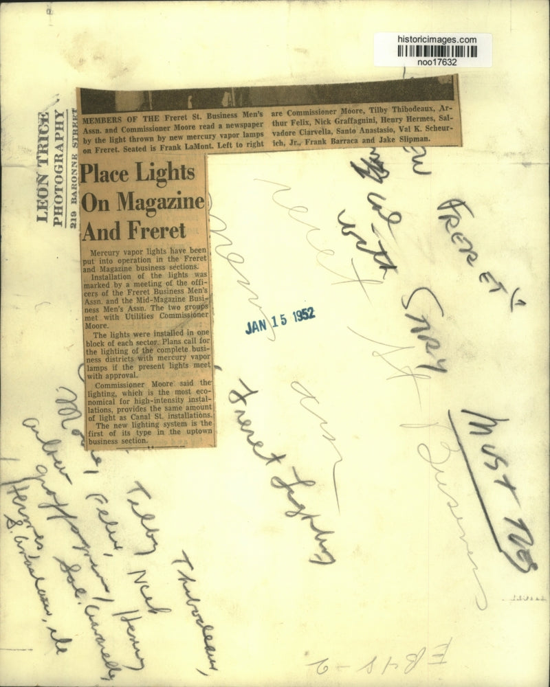 1952 Press Photo Commissioner Moore reads news paper under new lights