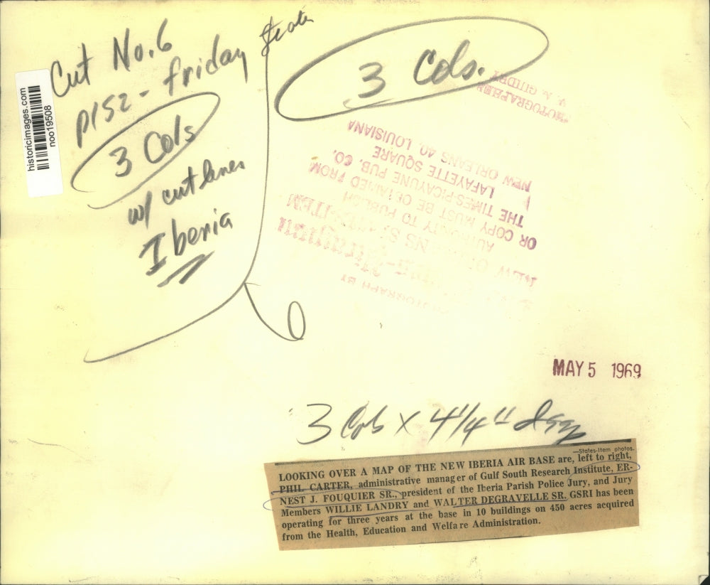 1969 Press Photo GSRI members look over a map of the base where they operate.