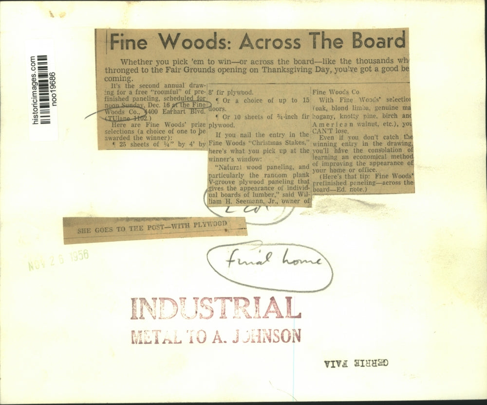 1956 Press Photo Gerrie Faia examines a wood paneling at the Fine Woods Company