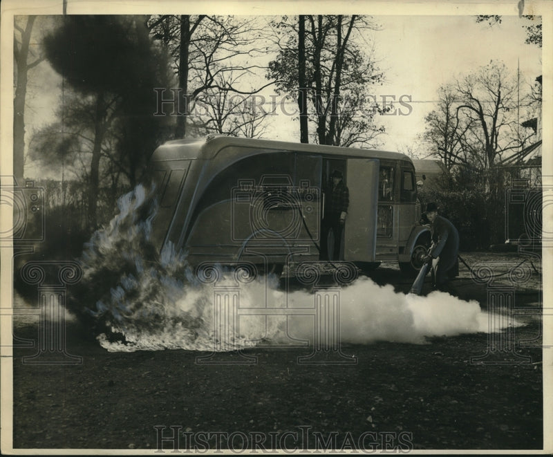 Load image into Gallery viewer, 1940 Press Photo Engineer Puts Out Ground Fire with Dry-Ice Gas in Demonstration
