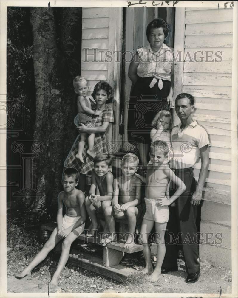 1962 Press Photo Huey Gonzales stands with his family at their home in Violet- Historic Images
