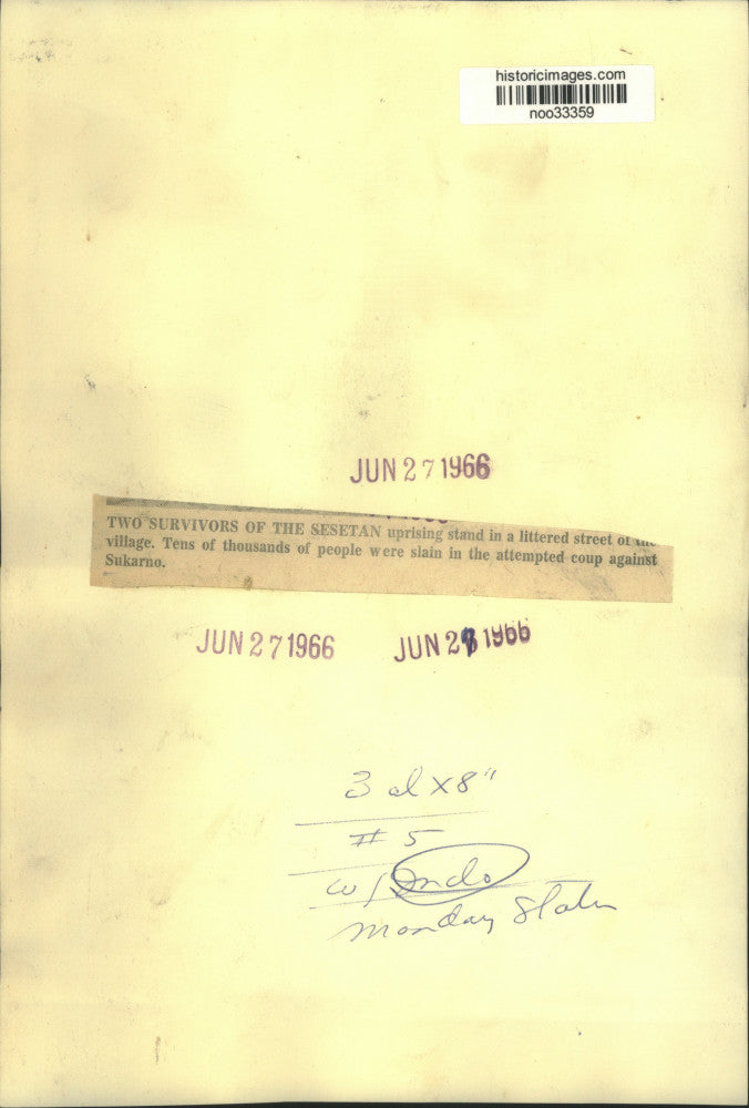 1966 Press Photo Two survivors of Sesetan uprising stand in littered street