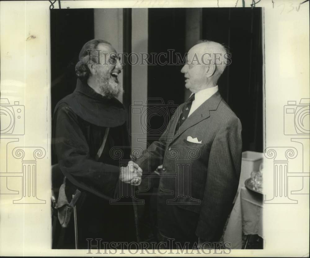 1977 Press Photo Reverend Loren Fuchs, O.F.M., is greeted by Leon Sarpy