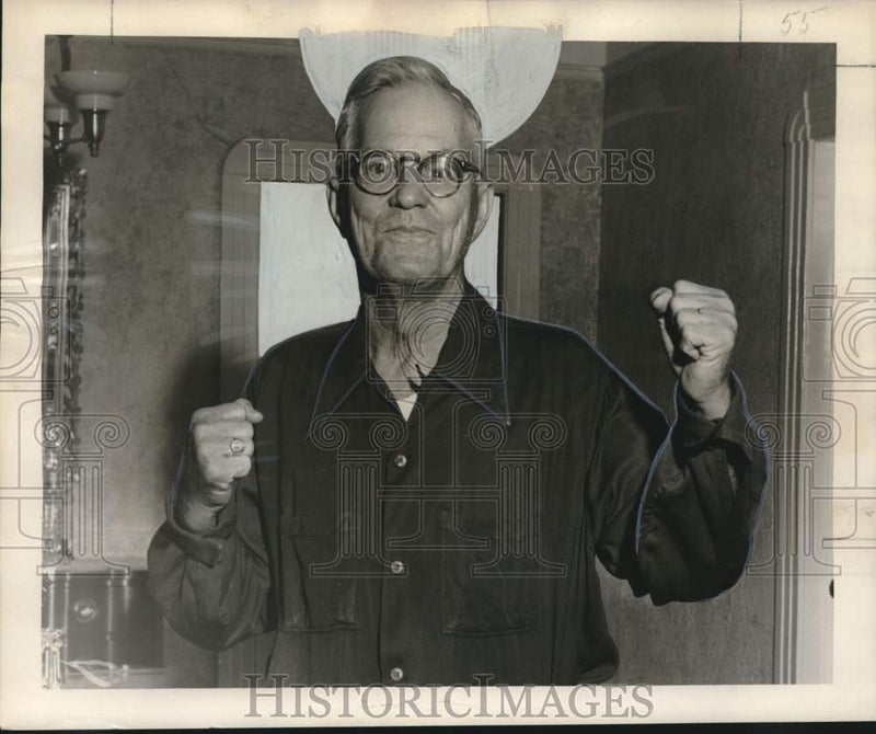 Load image into Gallery viewer, 1953 Press Photo Leonce Miller showing how he stopped a robber in his store
