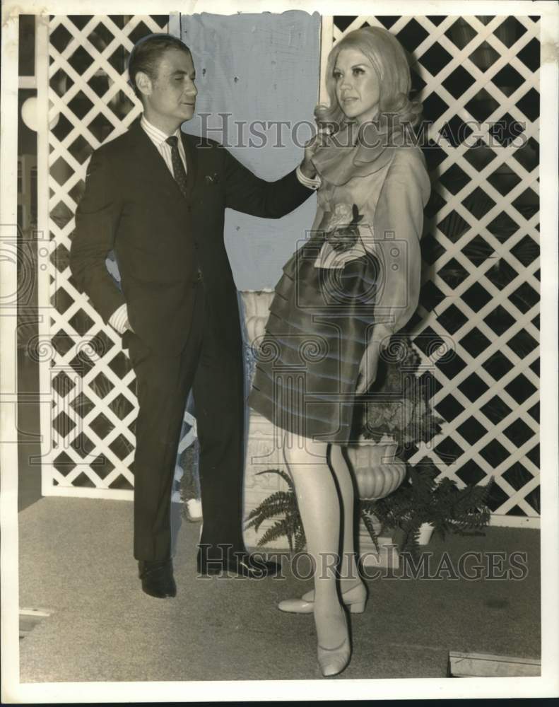 1968 Press Photo Morton Myles, fashion designer, looks over cocktail dress- Historic Images