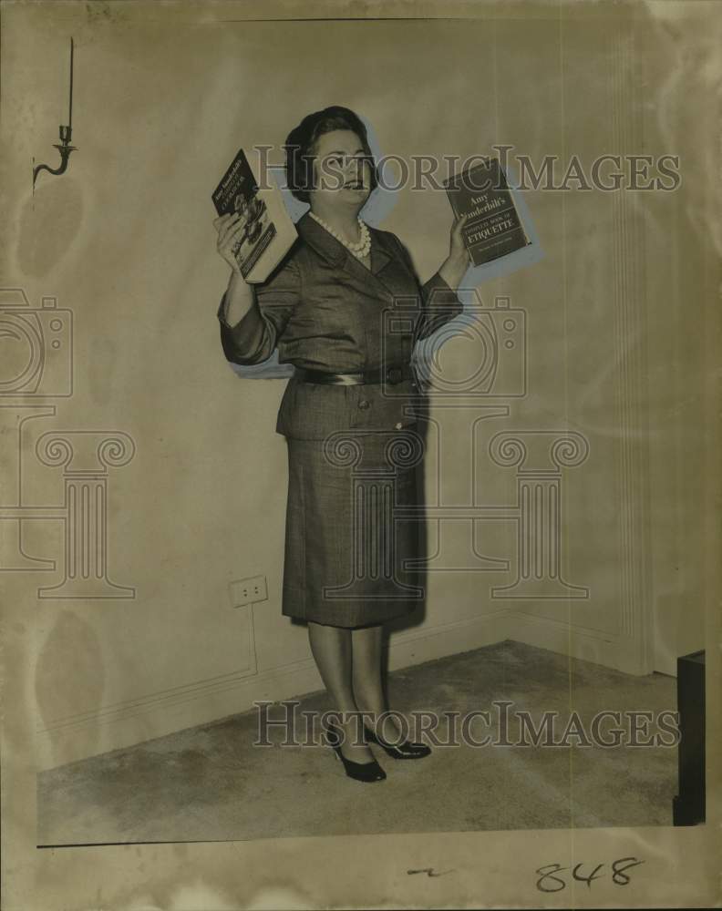 1961 Press Photo Amy Vanderbilt shows how she uses books for dumbbells