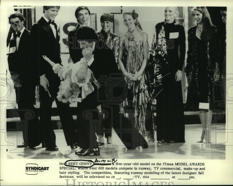 Load image into Gallery viewer, 1979 Press Photo Bert Convy dances with a young model at the ITmsa Model Awards.
