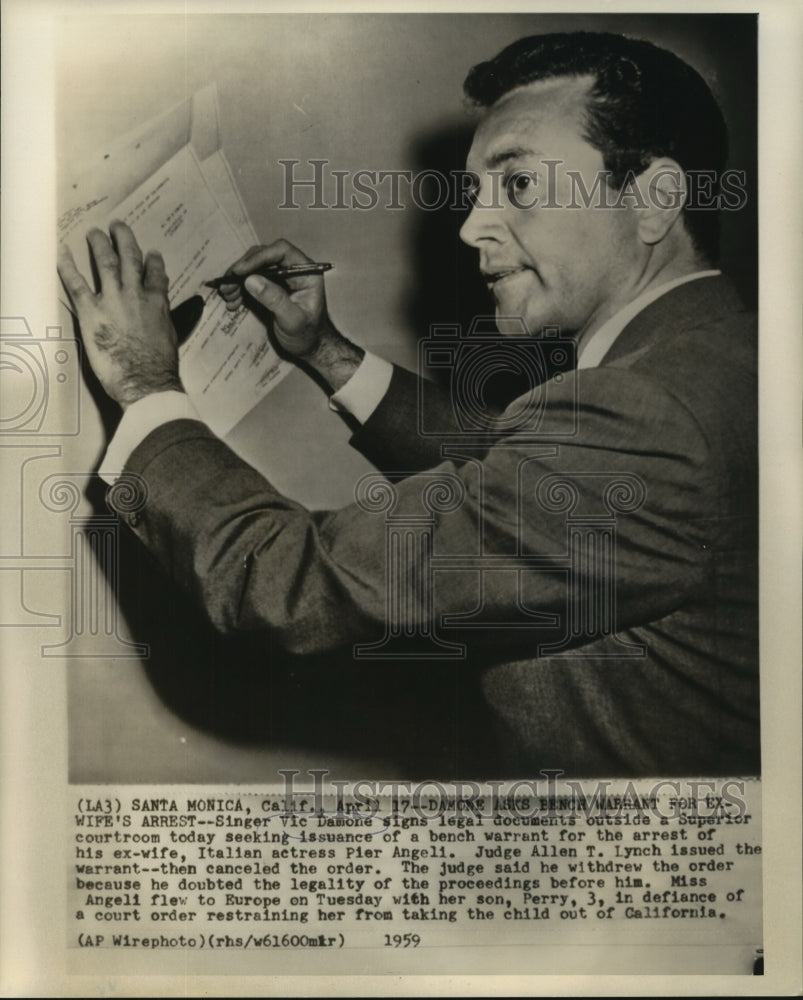1959 Press Photo Singer Vic Damone Signing Legal Documents In Santa Monica