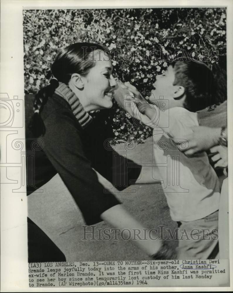 1964 Press Photo Christian Devi Brando leaps joyfully to his mother Anna Kashfi
