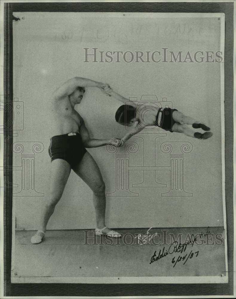 Load image into Gallery viewer, 1937 Press Photo Eddie Reggis, Jr. &amp; Sr. Eddie Sr. gives his son a lift
