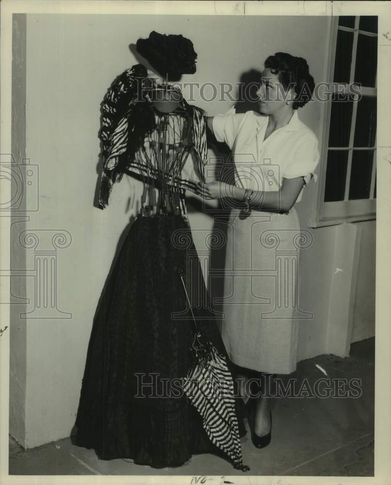 1954 Press Photo Enid Robbins examines &quot;Gay Nineties&quot; outfit for fashion show
