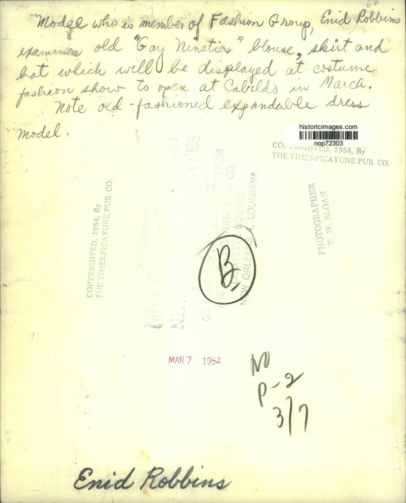 1954 Press Photo Enid Robbins examines "Gay Nineties" outfit for fashion show