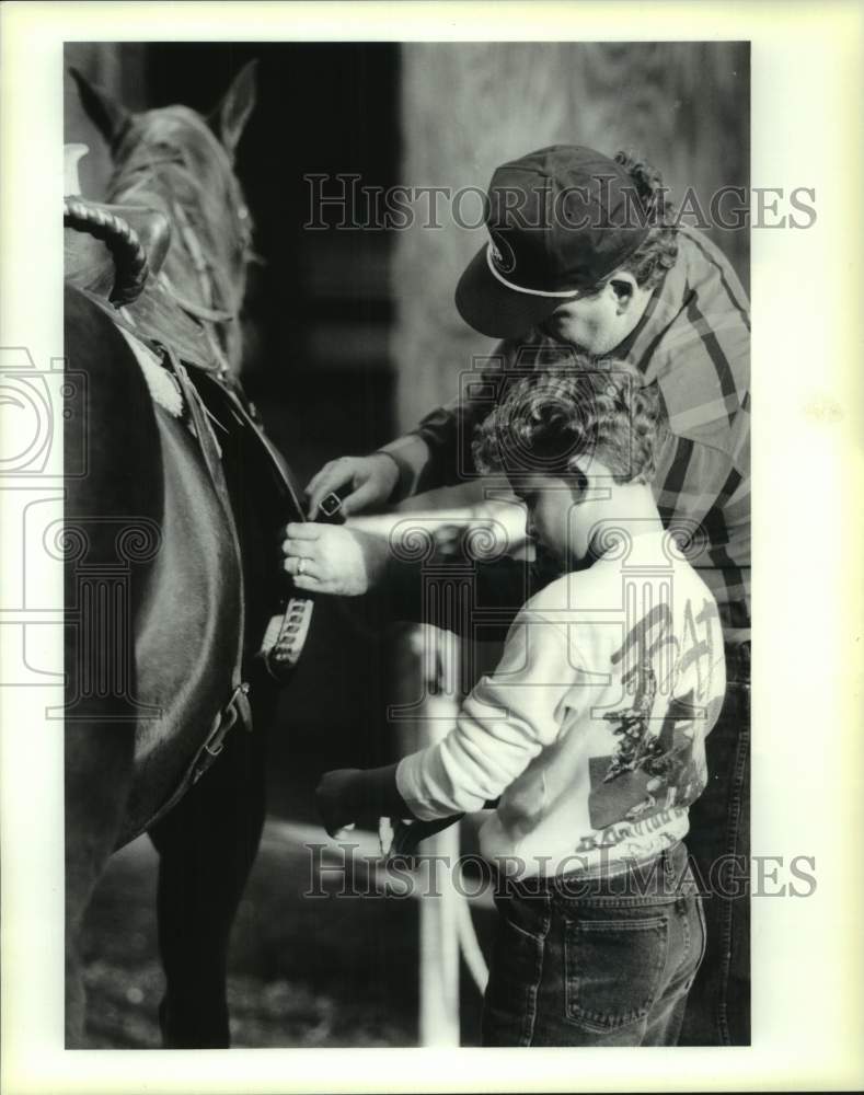 1990 Press Photo Robert Schwegmann helps his son, Robert on New Orleans farm.- Historic Images