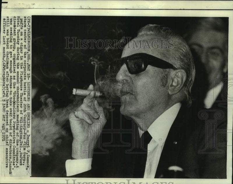 Load image into Gallery viewer, 1971 Press Photo Darryl Zanuck puffs cigar at annual shareholders meeting
