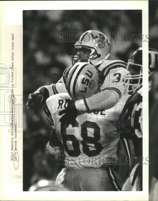 1987 Press Photo Ruffin Rodrigus picks up Victor Jones after Football Touchdown- Historic Images