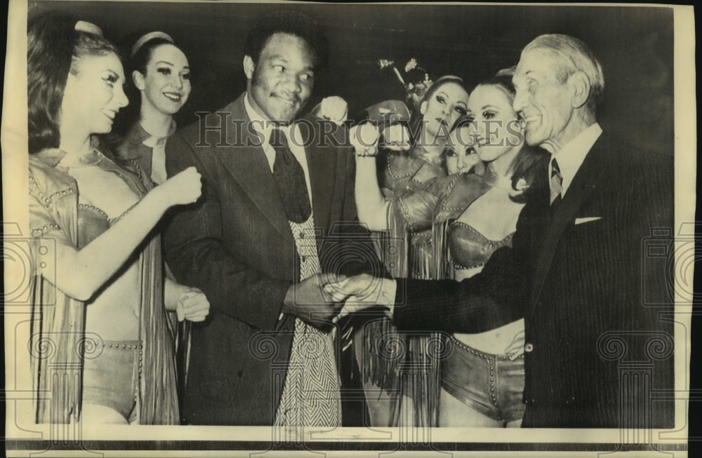 1973 Press Photo Boxer George Foreman and Others at Lido Night Club in Paris- Historic Images