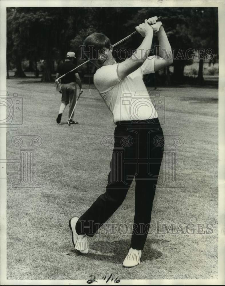 1970 Press Photo Golfer Donald Millet takes a practice swing with an iron- Historic Images