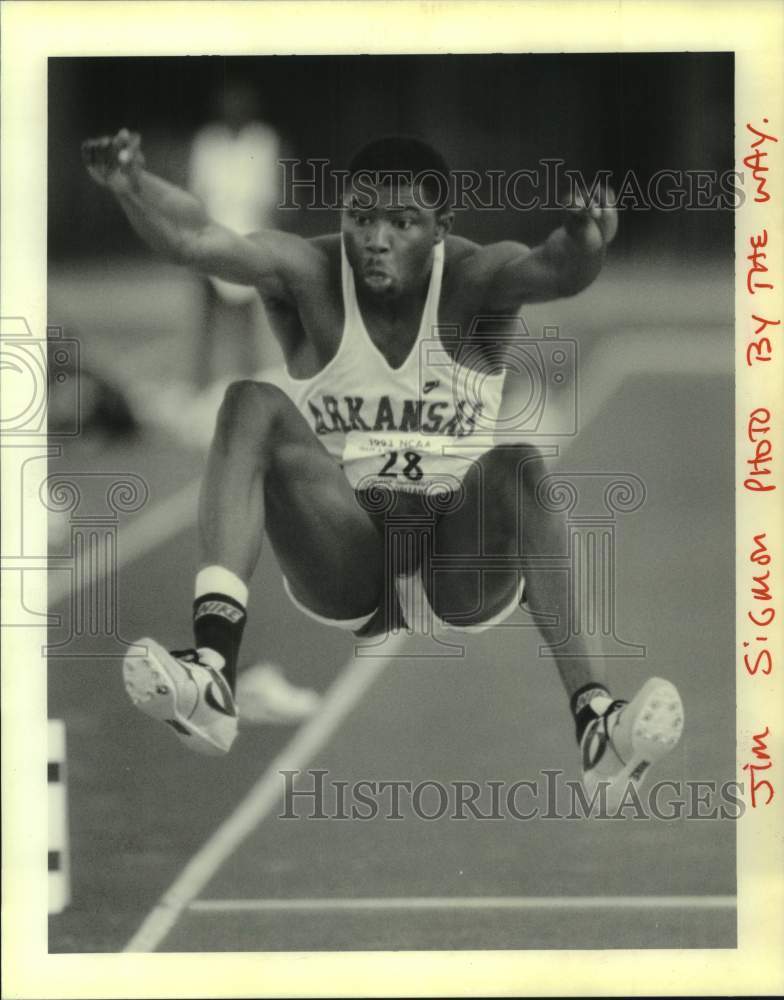 1993 Press Photo Arkansas track athlete #28 leaps in air for long jump event- Historic Images