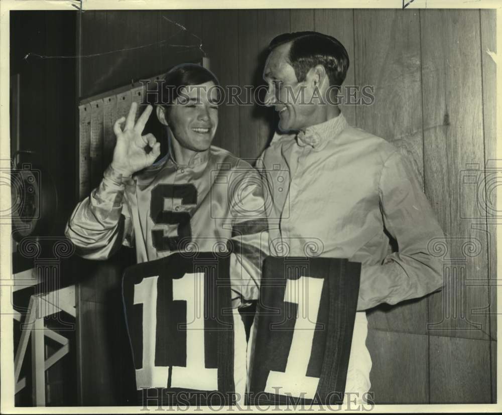 Press Photo Jockeys Tony Munster #11 and Jimmy Nichols #1 hold up racing numbers- Historic Images