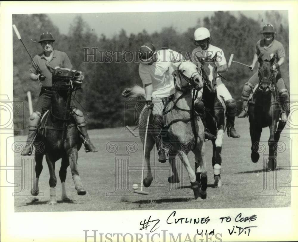 1990 Press Photo Player strikes the ball as opponents watch in Polo match- Historic Images