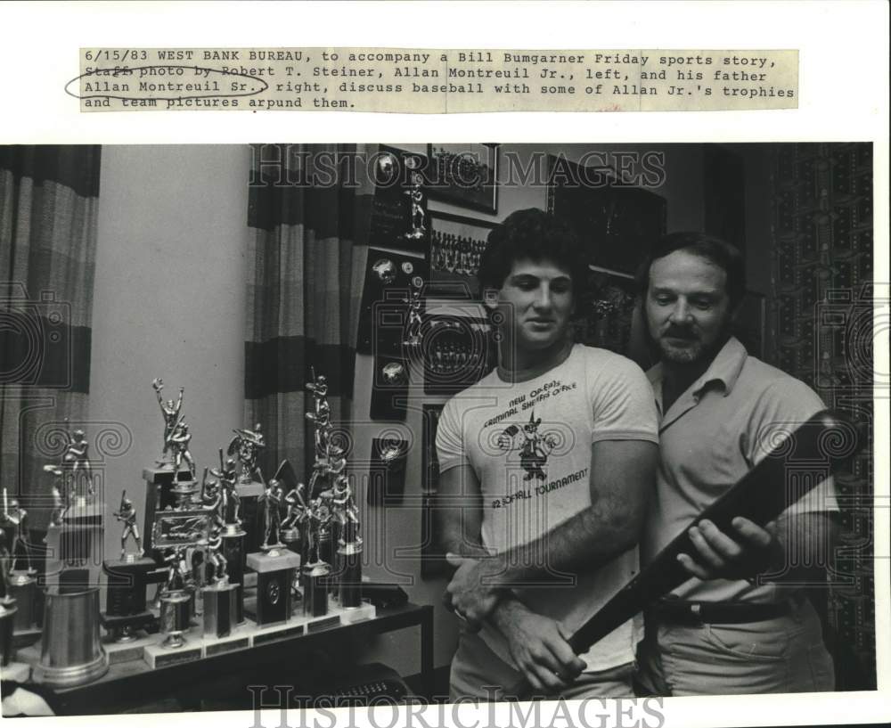 1983 Press Photo Baseball player Allan Montreuil Jr looks at trophies with dad- Historic Images