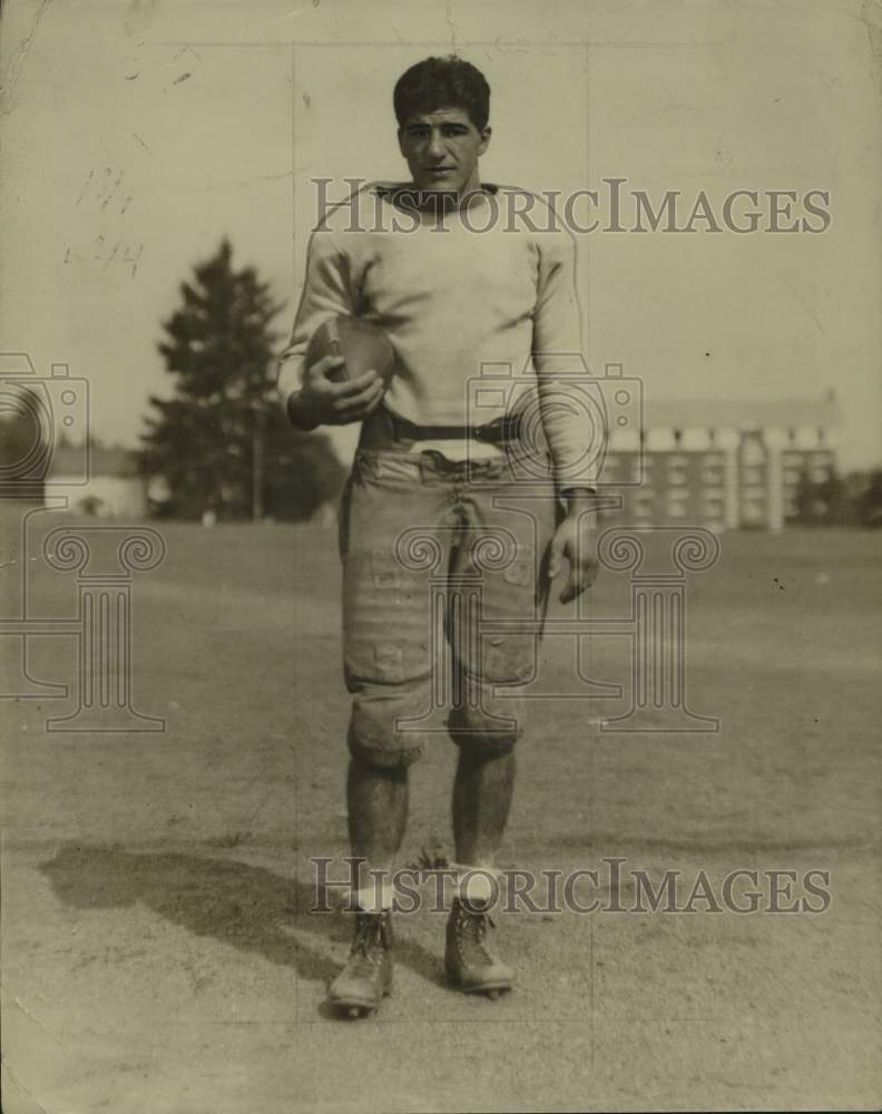 Press Photo Football player Bud Pozzo, an end, poses on practice field with ball- Historic Images