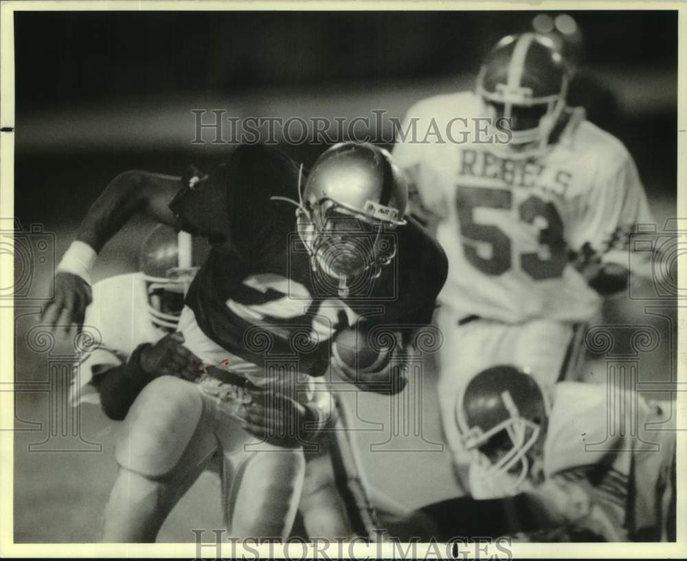 1989 Press Photo Higgins football player #20 is dragged down in Riverdale game- Historic Images