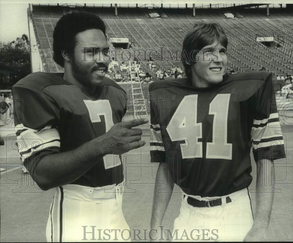 1976 Press Photo Football player Mike Price talks with teammate before a game- Historic Images