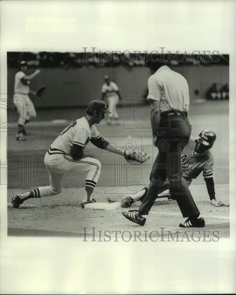 1977 Press Photo Baseball player Pat Scanlon attempts to tag sliding Iowa player- Historic Images