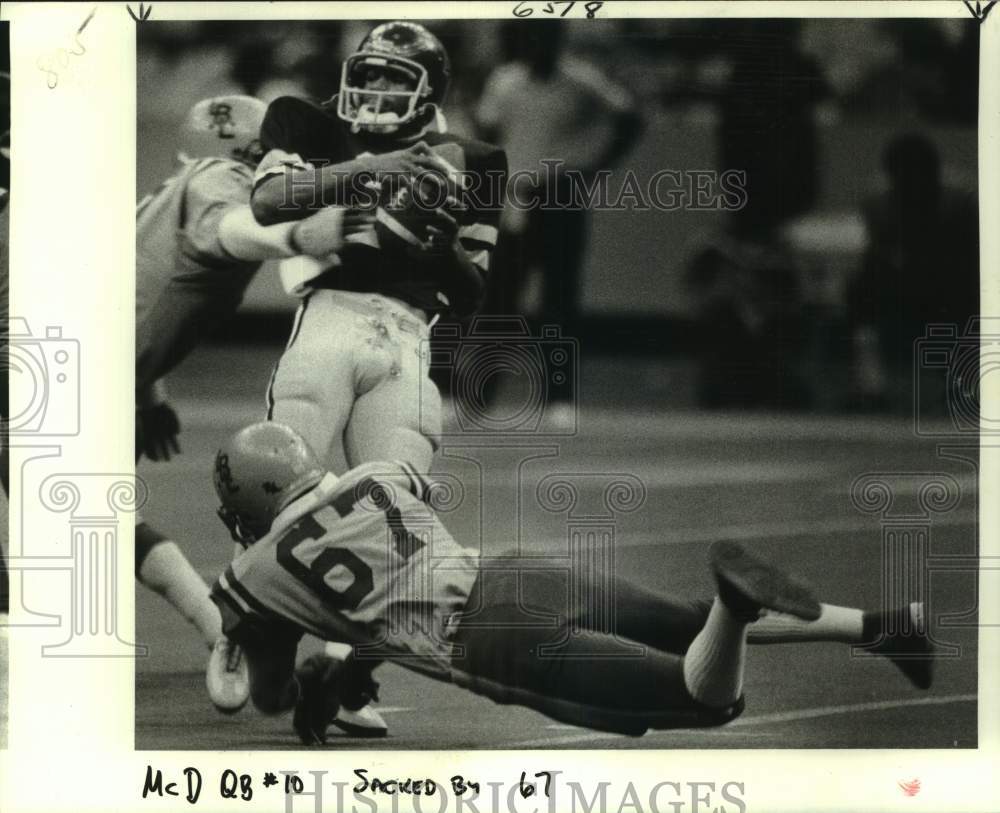 1981 Press Photo McDonogh 35 football quarterback Jerome Ross is sacked by Badon- Historic Images