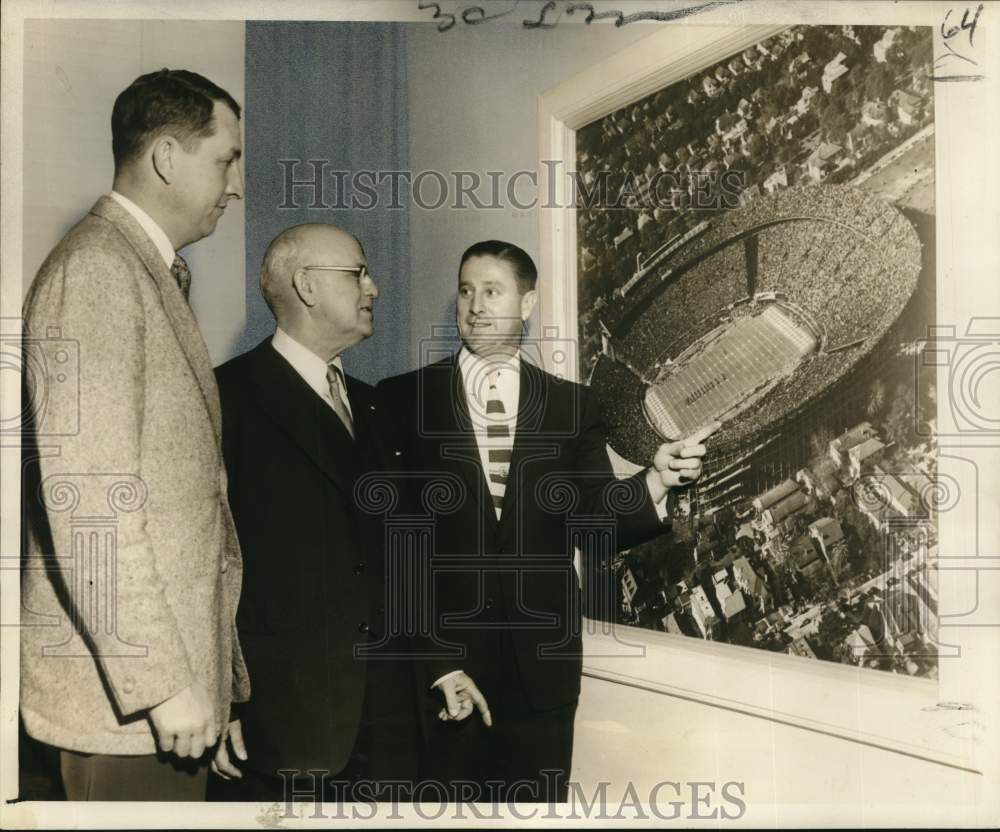 1954 Press Photo Monk Simon shows Navy officials image of packed Sugar Bowl- Historic Images