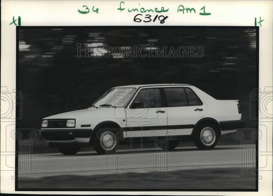 1987 Press Photo Volkswagen Jetta Four Door Driving Down the Road- Historic Images