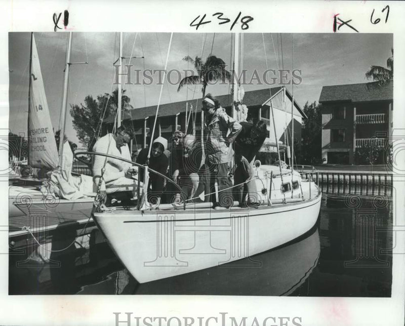 Load image into Gallery viewer, 1978 Press Photo Sailing students of the Offshore Sailing School on a boat
