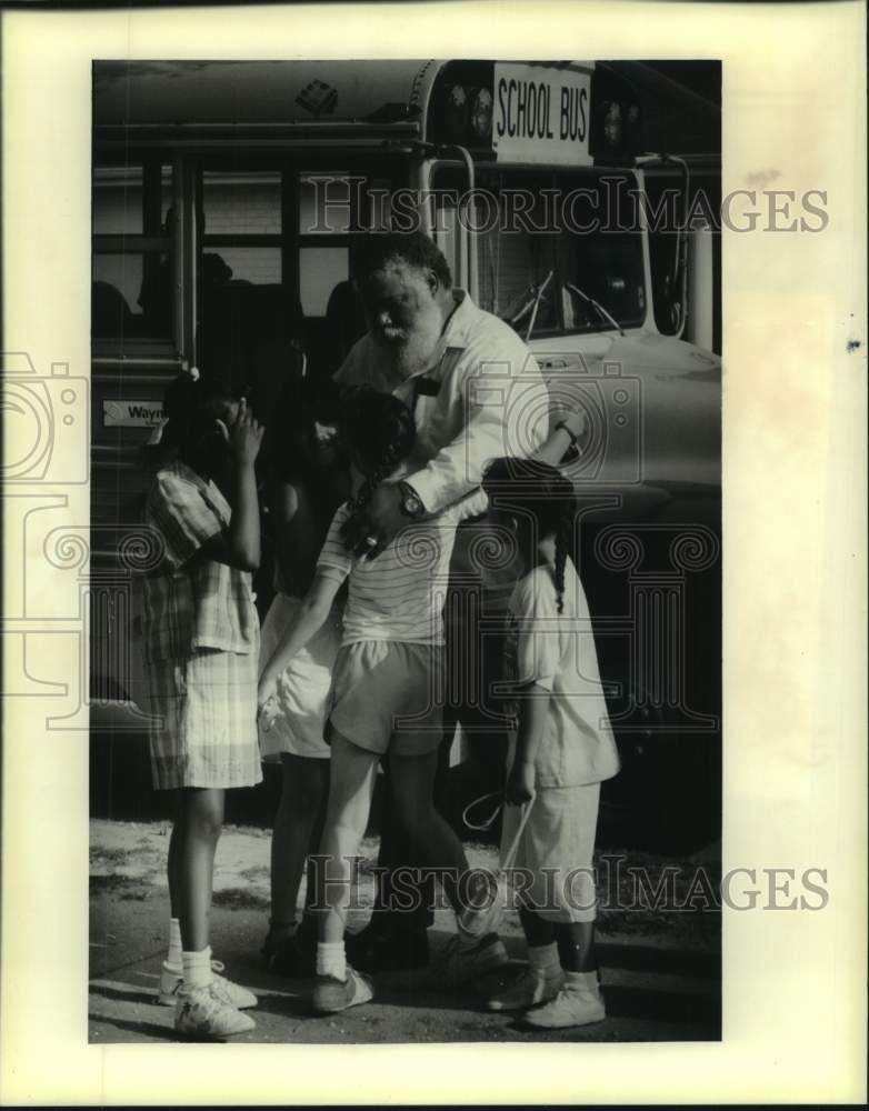 Load image into Gallery viewer, 1988 Press Photo Public school bus driver gets big hug from some of his riders
