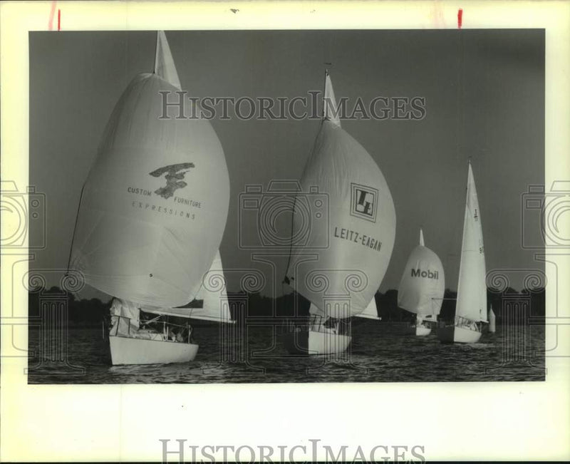 Load image into Gallery viewer, 1989 Press Photo Sailboats display corporate spinnakers on Lake Pontchartrain
