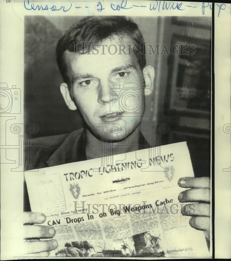 1970 Press Photo Specialist Fitzpatrick holds copy of &quot;Tropic Lighting News.&quot;