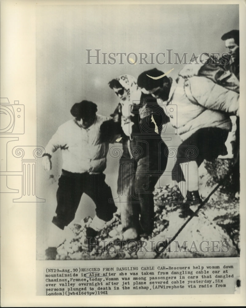 1961 Press Photo Rescuers help woman down mountainside in Alps in France
