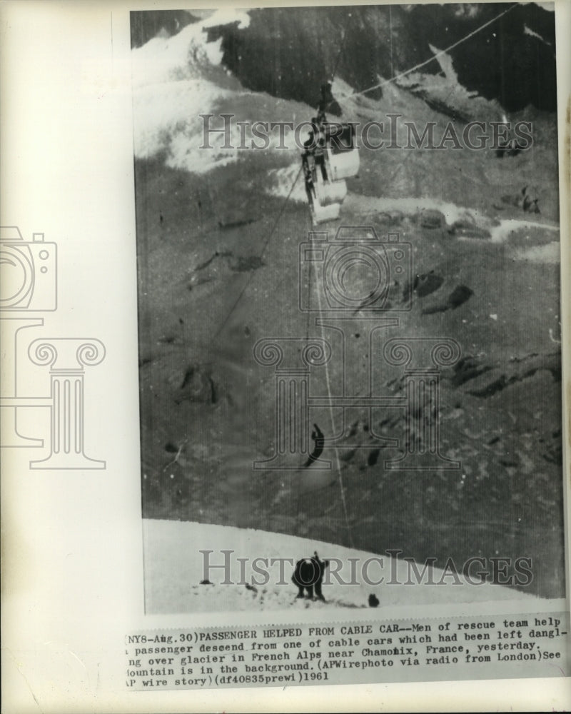 1961 Press Photo Rescue team help passenger descend from cable car in the Alps