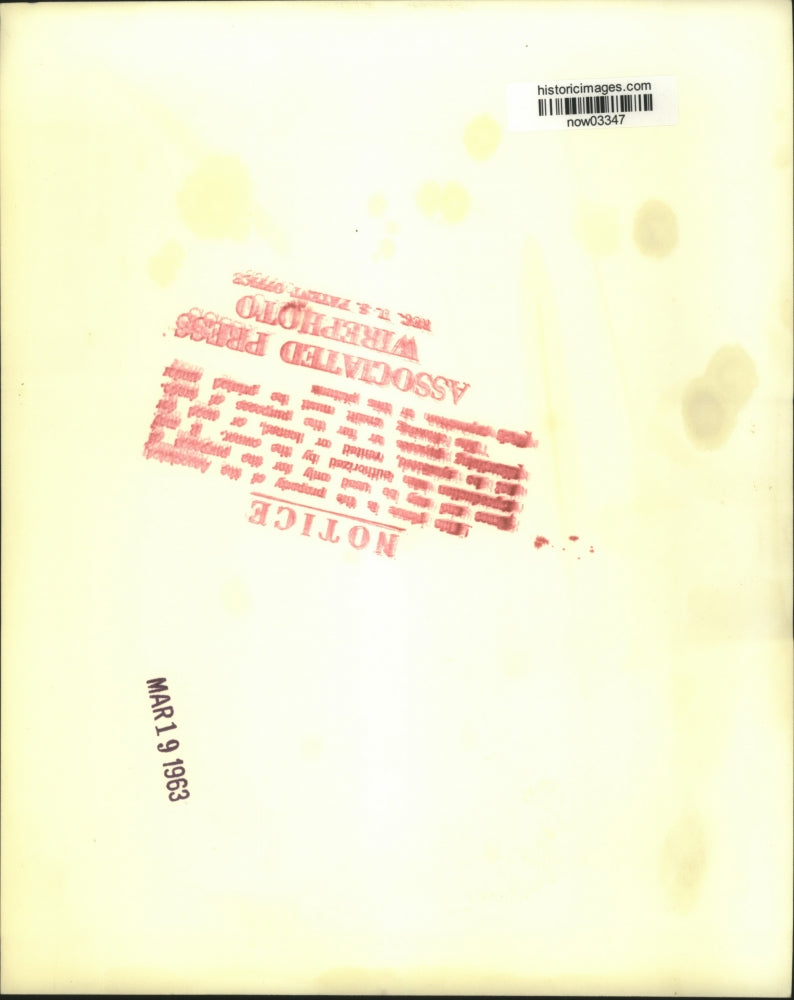 1963 Press Photo Father Abel Garreau points to Viet Cong shelling damage