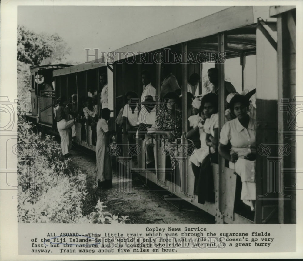 1970 Press Photo Natives &amp; tourists ride train through sugarcane fields of Fiji